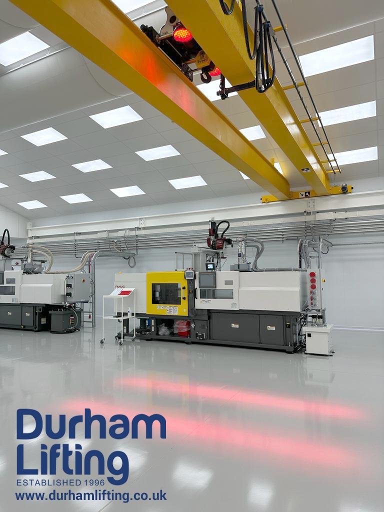 Projected overhead crane warning light on industrial floor